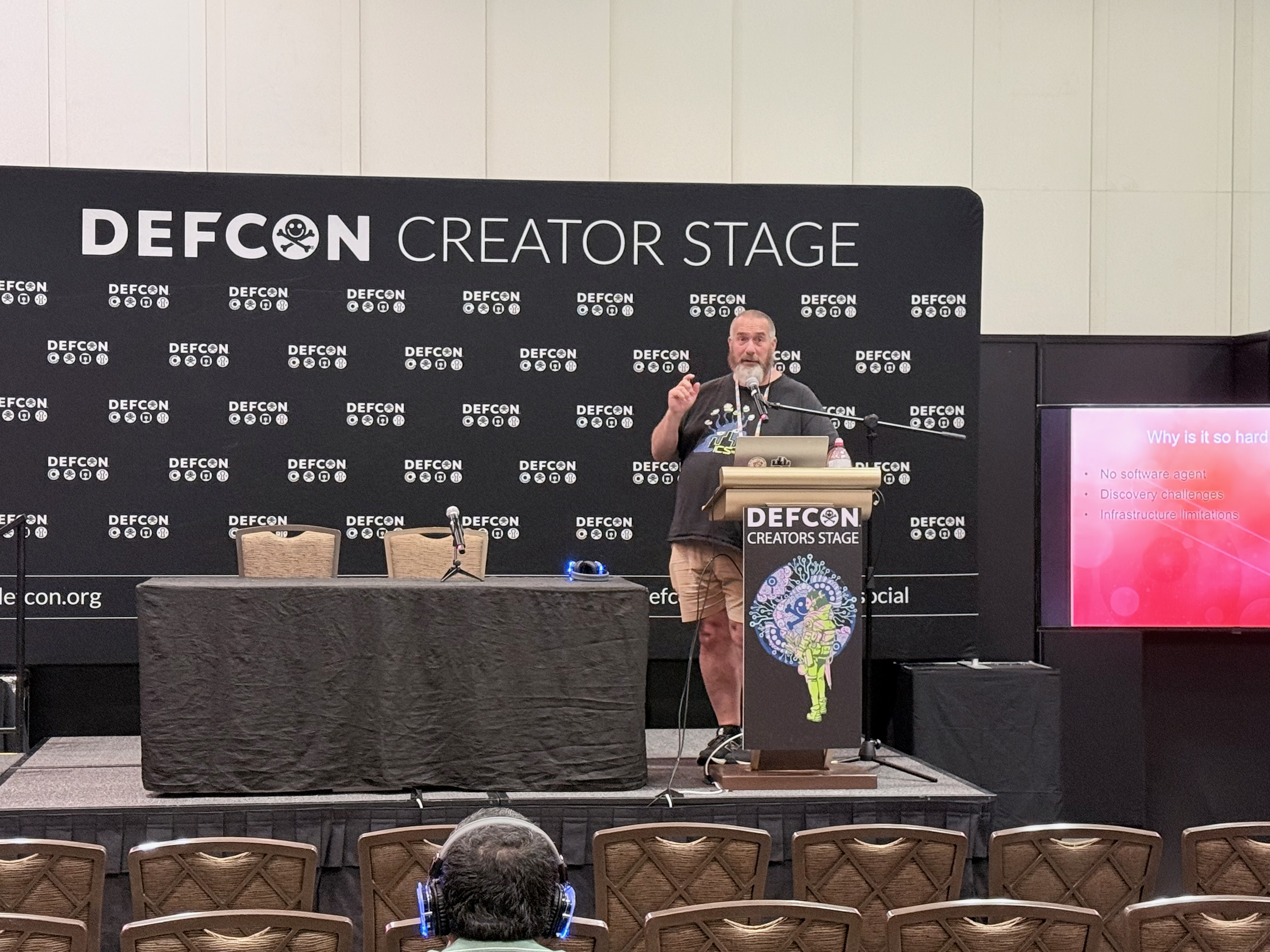 ICS Village co-founder presenting on the DEF CON Creator Stage in front of the village audience.